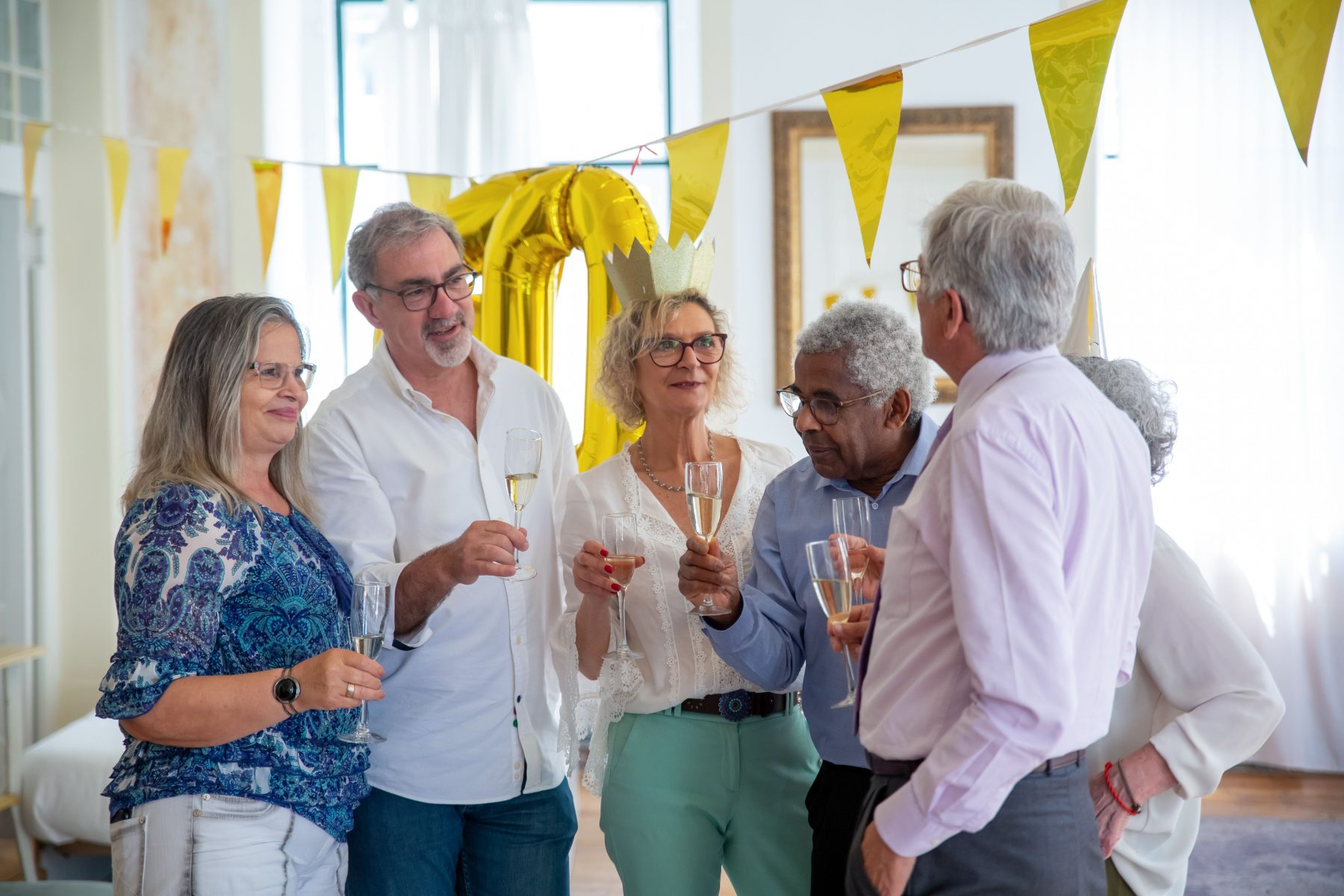 Group of friends raising glasses at a birthday celebration